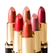 Five luxury lipsticks in varying shades of red and pink with gold tubes arranged in a display