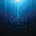 Abstract blue digital background with cascading light particles and rays emanating from center