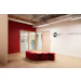 Modern office interior with red curved seating and glass doors, displaying IBG and Centdegres corporate logos on white wall
