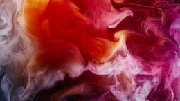 Abstract fluid art with swirling pink, red, orange, and purple smoke-like patterns creating a dynamic, colorful background
