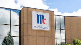 McCormick company logo displayed on brick building exterior with blue and red geometric design