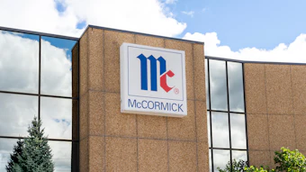 McCormick company logo displayed on brick building exterior with blue and red geometric design