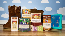 Toy Story branded product collection including cowboy boots, deodorant, soap, and accessories arranged on wooden surface with cloud backdrop