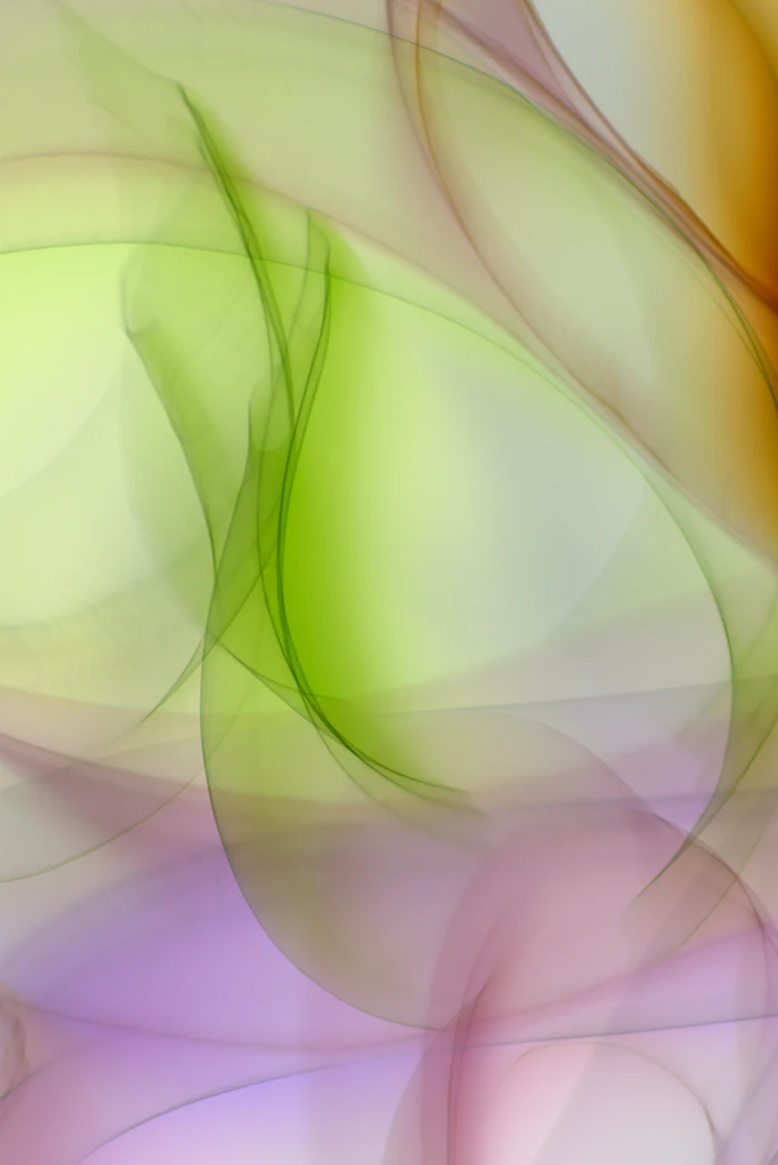Abstract gradient background with flowing green, pink, and purple tones creating soft, organic shapes